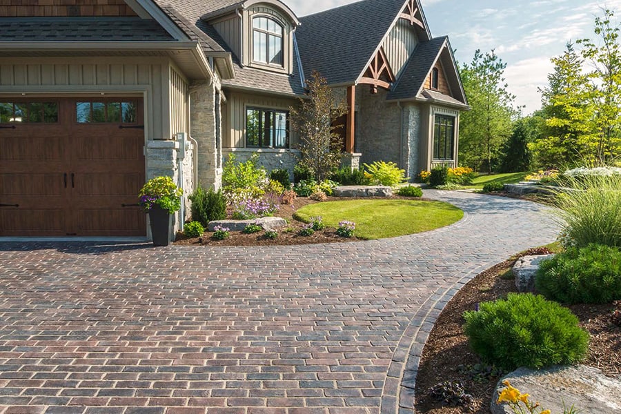 Paver driveway with clean borders and inlay pattern