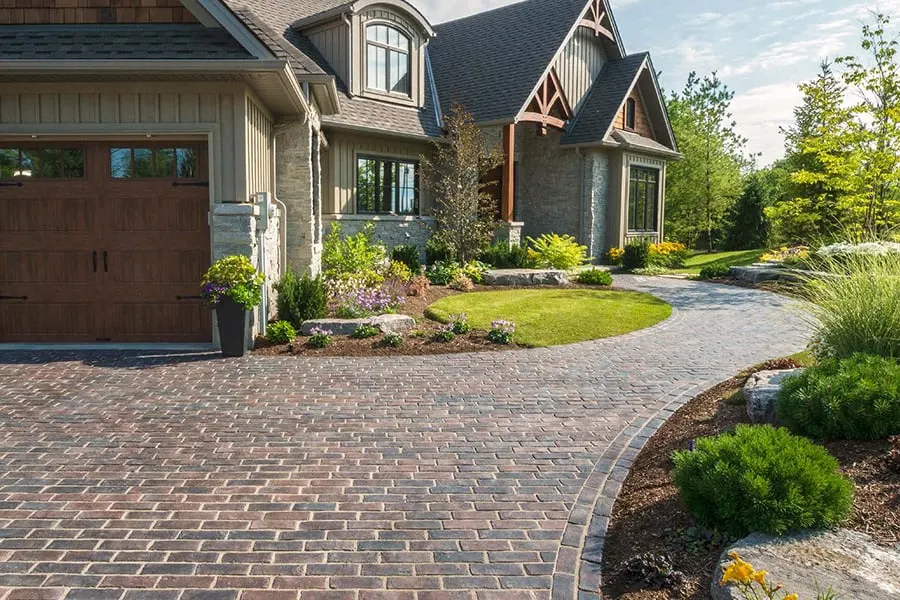 Paver driveway with clean borders and inlay pattern