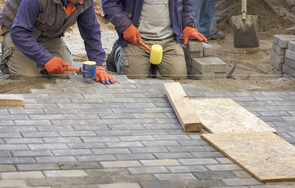 Crew preparing and installing a new walkway surface
